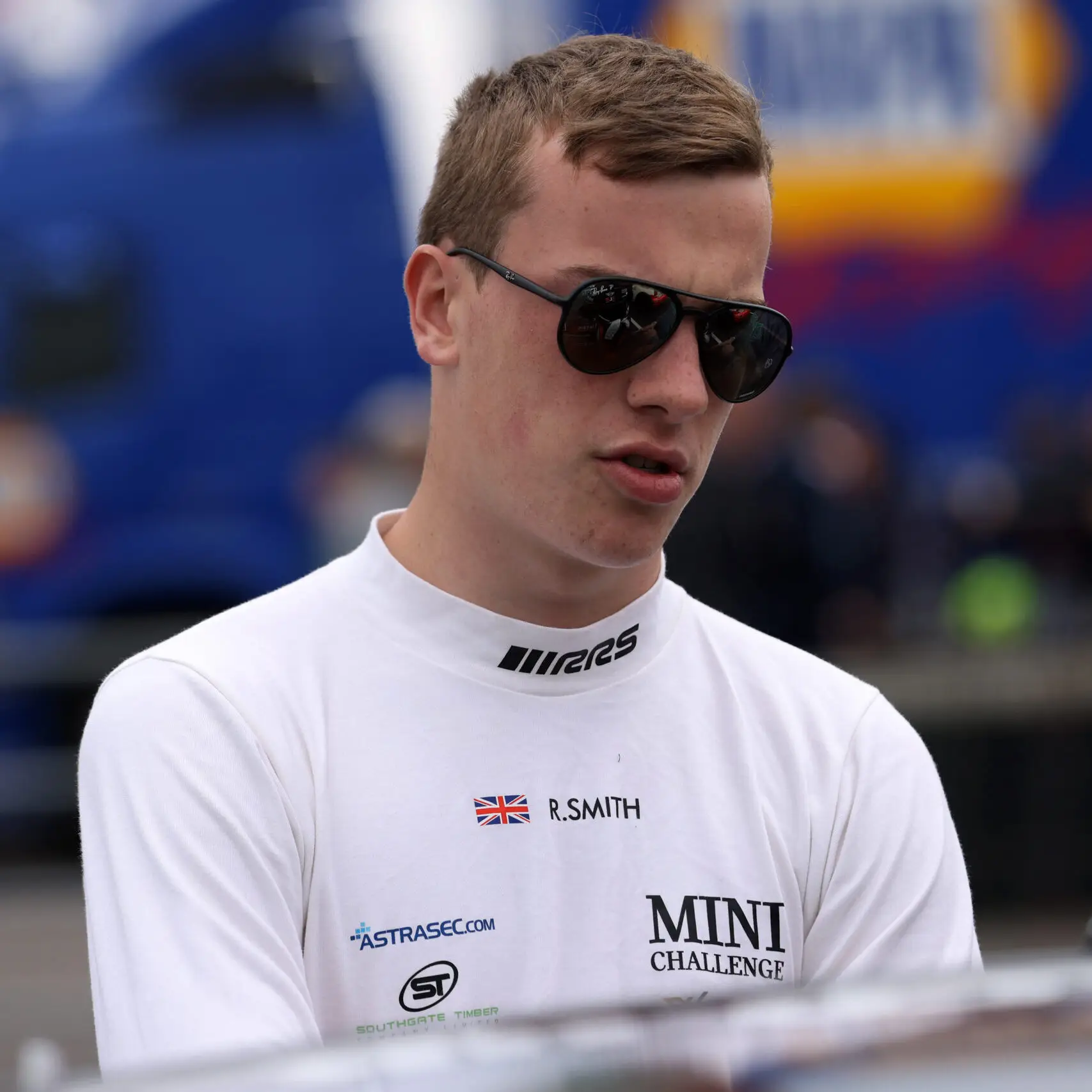 picture of mini challenge driver with sunglasses over the top of car bonnet in fireproof baselayer