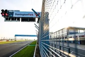 Donnington park photo down pit straight, wire mesh with donnington sign over gantry https://www.jakobebrey.com/